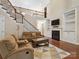Spacious living room with a cozy fireplace, a staircase, and built in cabinets at 166 Wilson Lake Rd, Mooresville, NC 28117