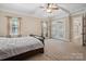 Spacious main bedroom featuring a trey ceiling, fan, and private access to the home's exterior at 166 Wilson Lake Rd, Mooresville, NC 28117