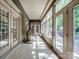 Extended sunroom with tile flooring, comfortable hanging chair and lots of natural light at 166 Wilson Lake Rd, Mooresville, NC 28117