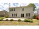Back exterior with a stone fire pit, sliding glass doors and windows overlooking the backyard at 1965 Leesburg Dr, Clover, SC 29710