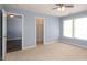 Bedroom featuring neutral carpet, two windows allowing for natural light, and a closet at 1965 Leesburg Dr, Clover, SC 29710