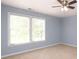 Bedroom featuring two windows allowing for natural light, complemented by a ceiling fan at 1965 Leesburg Dr, Clover, SC 29710