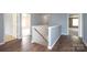 Second floor hallway with two doors and hardwood flooring at 1965 Leesburg Dr, Clover, SC 29710