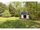 View of a shed situated in a fenced backyard, with green grass at 1965 Leesburg Dr, Clover, SC 29710