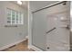 Bathroom featuring a glass block window and accessible walk-in shower with grab bars at 2150 Quiet Creek Pl, Rock Hill, SC 29732