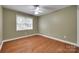 Bright bedroom with hardwood floors, a ceiling fan, and a large window at 2150 Quiet Creek Pl, Rock Hill, SC 29732