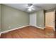 Well-lit bedroom with hardwood floors, ceiling fan, and closet for ample storage at 2150 Quiet Creek Pl, Rock Hill, SC 29732