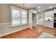 Bright dining area featuring hardwood floors, a window with blinds, and white trim at 2150 Quiet Creek Pl, Rock Hill, SC 29732