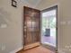 Elegant wood front door opening to a view of the inviting front porch and landscaped yard at 2150 Quiet Creek Pl, Rock Hill, SC 29732