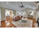 Open-concept living room featuring hardwood floors, a fireplace, and views of the dining and kitchen areas at 2150 Quiet Creek Pl, Rock Hill, SC 29732