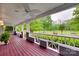 Inviting covered porch featuring a ceiling fan and beautiful views of the landscaped lawn at 2150 Quiet Creek Pl, Rock Hill, SC 29732