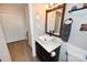 Bathroom with white vanity, framed mirror, and walk-in shower at 2263 Starbrooke Dr, Newton, NC 28658