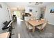 Spacious dining area open to kitchen, featuring gray floors and natural light from sliding glass doors at 2263 Starbrooke Dr, Newton, NC 28658