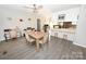 Open-concept dining room with adjacent kitchen area and sleek gray flooring at 2263 Starbrooke Dr, Newton, NC 28658