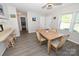 Open dining area featuring gray floors, bar seating, and views into kitchen and entryway at 2263 Starbrooke Dr, Newton, NC 28658