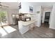 Bright kitchen featuring stainless steel appliances, breakfast bar with seating, and access to the deck at 2263 Starbrooke Dr, Newton, NC 28658