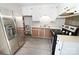 Modern kitchen with stainless steel appliances, white cabinetry, and updated flooring at 2263 Starbrooke Dr, Newton, NC 28658