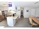 Well-lit kitchen featuring bar seating, stainless steel fridge, and tile backsplash at 2263 Starbrooke Dr, Newton, NC 28658