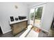 Kitchenette area with stainless steel refrigerator, modern appliances, and access to the outdoor deck at 2263 Starbrooke Dr, Newton, NC 28658