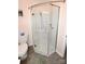 Shower with glass doors, overhead shower head, and handle bars at 2263 Starbrooke Dr, Newton, NC 28658