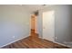 Comfortable bedroom with wood-look floors, doors, and neutral walls at 2416 Hart Rd, Charlotte, NC 28214