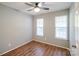 Bedroom with wood-look flooring, a ceiling fan, and windows for ample natural light at 2416 Hart Rd, Charlotte, NC 28214
