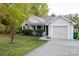 Charming single-Gathering home with a one-car garage, mature landscaping, and a welcoming entrance at 2416 Hart Rd, Charlotte, NC 28214