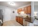 Kitchen features stainless steel appliances, granite countertops, and wooden cabinetry, illuminated by modern lighting at 2416 Hart Rd, Charlotte, NC 28214