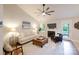 Bright living room with a ceiling fan, fireplace, and neutral decor, creating a comfortable and inviting space at 2416 Hart Rd, Charlotte, NC 28214