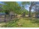 Spacious backyard with lush greenery and additional storage sheds at 2609 Lowell Rd, Gastonia, NC 28054