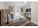 Bright bedroom with hardwood floors, neutral walls, decorative art and a large window at 2609 Lowell Rd, Gastonia, NC 28054