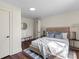 Cozy bedroom features neutral decor, hardwood floors, and a comfortable seating area at 2609 Lowell Rd, Gastonia, NC 28054