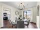 Open dining area features modern chandelier, hardwood floors, and views into the kitchen at 2609 Lowell Rd, Gastonia, NC 28054