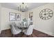 Bright dining area features modern chandelier, hardwood floors, and neutral paint at 2609 Lowell Rd, Gastonia, NC 28054