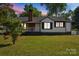 Charming single-story home with a brick chimney, a covered porch, and a well-maintained front lawn at 2609 Lowell Rd, Gastonia, NC 28054