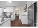 Bright kitchen features white cabinets, granite countertops, stainless steel appliances, and open shelving at 2609 Lowell Rd, Gastonia, NC 28054
