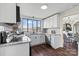 Bright kitchen features white cabinets, granite countertops, stainless steel appliances, and gray tile backsplash at 2609 Lowell Rd, Gastonia, NC 28054