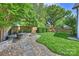 Landscaped backyard featuring a stone patio with fire pit and seating area, plus a grassy play area with playground at 2841 Attaberry Dr, Charlotte, NC 28205