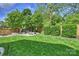 Expansive backyard featuring a lush lawn, seating area with fire pit, and a wooden fence at 2841 Attaberry Dr, Charlotte, NC 28205