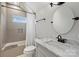 Bright bathroom featuring a vanity with marble countertops, ceramic tile, and bathtub and shower at 2841 Attaberry Dr, Charlotte, NC 28205
