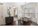 Charming dining area with dark wood floors, modern chandelier, and view of the entryway at 2841 Attaberry Dr, Charlotte, NC 28205