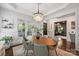 Bright dining room featuring modern lighting, hardwood floors, and elegant furnishings at 2841 Attaberry Dr, Charlotte, NC 28205
