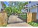 Gated driveway leading to a well-maintained home and lush landscaping at 2841 Attaberry Dr, Charlotte, NC 28205