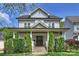 Charming two-story home with a covered front porch, manicured lawn, and lush landscaping at 2841 Attaberry Dr, Charlotte, NC 28205