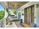 Cozy front porch featuring a swing, stone pillars, and a stylish wooden door at 2841 Attaberry Dr, Charlotte, NC 28205