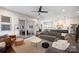Bright, open living room featuring modern decor, hardwood floors, and seamless flow to dining area and kitchen at 2841 Attaberry Dr, Charlotte, NC 28205