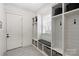 Well-organized mudroom with custom built-in storage, bench, and tiled floor at 2841 Attaberry Dr, Charlotte, NC 28205