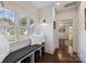 Cozy sitting area featuring a bench with pillows, lots of sunlight and dark hardwood floors at 2841 Attaberry Dr, Charlotte, NC 28205