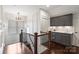 Upstairs wet bar with gray cabinetry, marble countertops, wine cooler, and dark wood flooring at 2841 Attaberry Dr, Charlotte, NC 28205