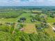 Stunning aerial view of a home and its surrounding landscape with lush greenery and blue skies at 286 Bell Farm Rd, Statesville, NC 28625